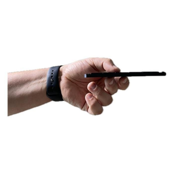 Guitar Thing seen edge-on in a hand, about as thin as a phone