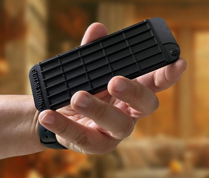 Guitar Thing held in a hand